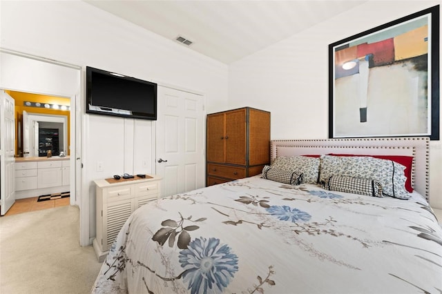 carpeted bedroom featuring ensuite bathroom