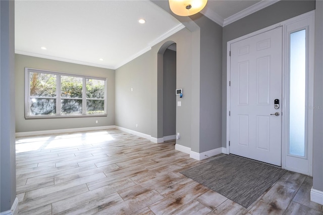 foyer with light hardwood / wood-style floors and ornamental molding