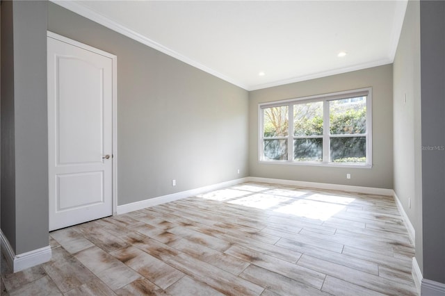 unfurnished room with crown molding and light hardwood / wood-style flooring