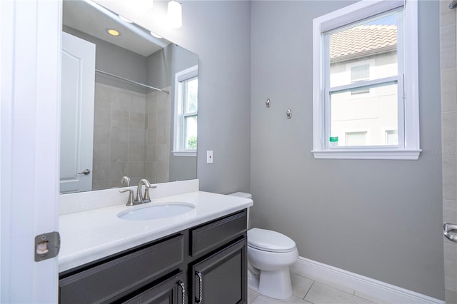 bathroom with tile patterned flooring, vanity, and toilet