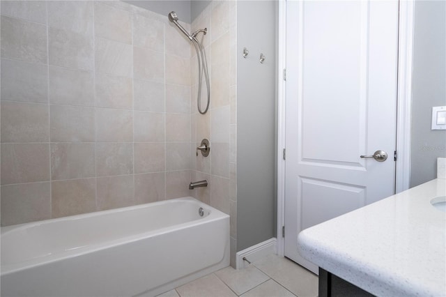 bathroom featuring tile patterned flooring, vanity, and tiled shower / bath combo