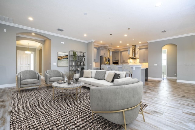 living room featuring light hardwood / wood-style floors and ornamental molding