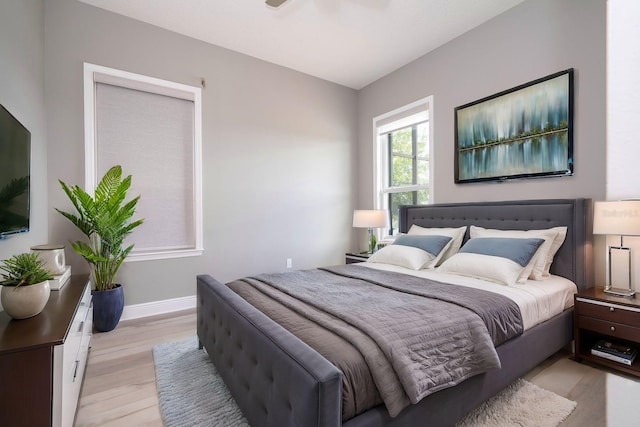 bedroom with ceiling fan and light hardwood / wood-style flooring