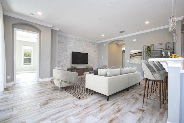 living room with light hardwood / wood-style flooring and ornamental molding