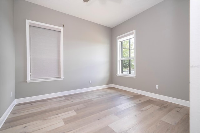 unfurnished room with light wood-type flooring