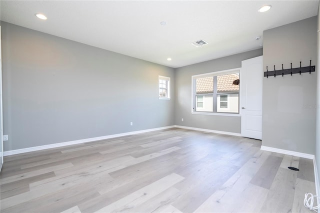 unfurnished room with light hardwood / wood-style floors