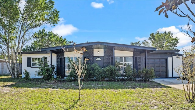 ranch-style home with a garage and a front yard