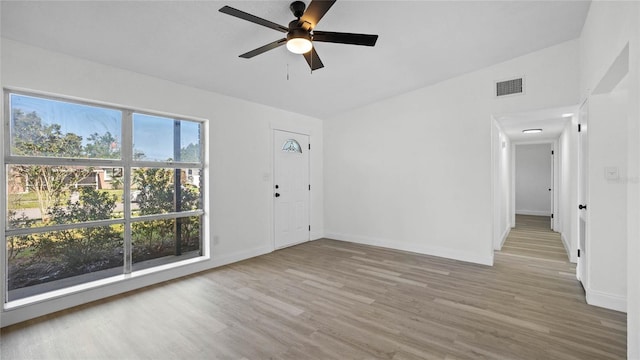 spare room featuring hardwood / wood-style flooring, ceiling fan, and vaulted ceiling