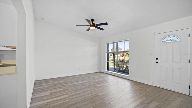 foyer entrance with light hardwood / wood-style floors, sink, and ceiling fan