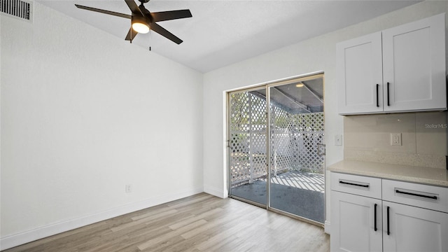 unfurnished dining area with ceiling fan and light hardwood / wood-style floors