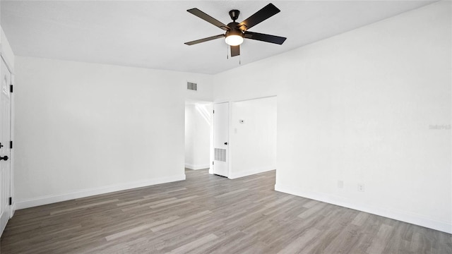 spare room with hardwood / wood-style floors and ceiling fan