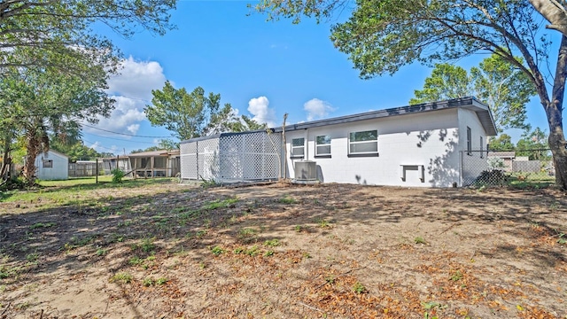 rear view of property featuring a sunroom