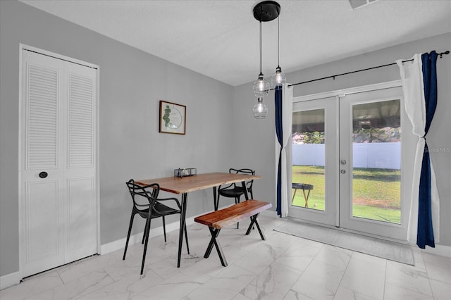 dining room with french doors and a textured ceiling