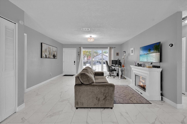 living room with a textured ceiling