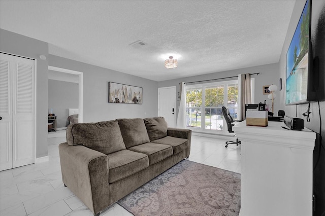 living room with a textured ceiling