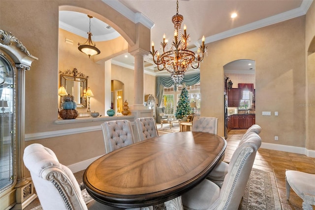 dining area with decorative columns, an inviting chandelier, and ornamental molding