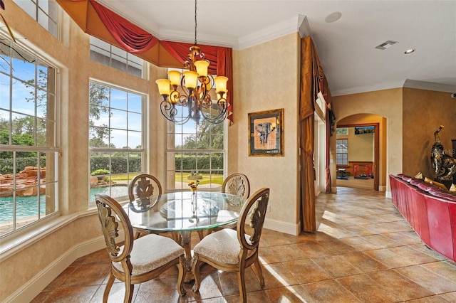 dining room featuring crown molding and a chandelier