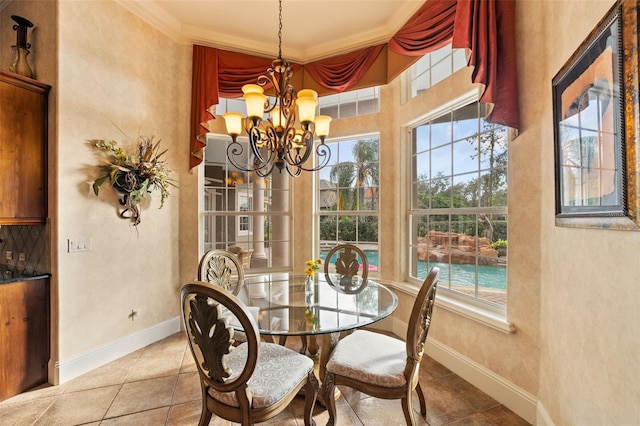 tiled dining space featuring an inviting chandelier and crown molding