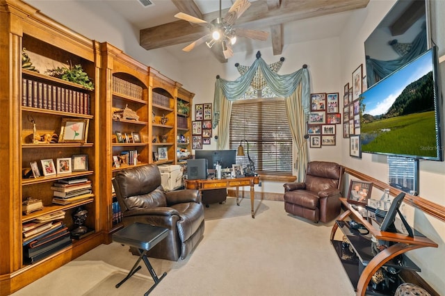 living area with beamed ceiling, light colored carpet, and ceiling fan