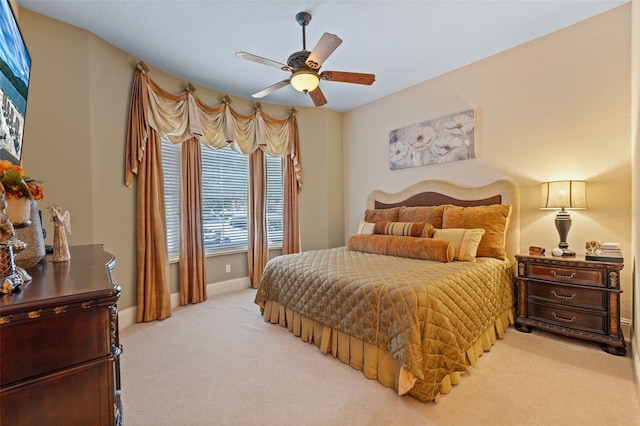 bedroom with ceiling fan and light carpet