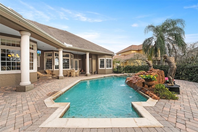 view of pool with a patio area and pool water feature