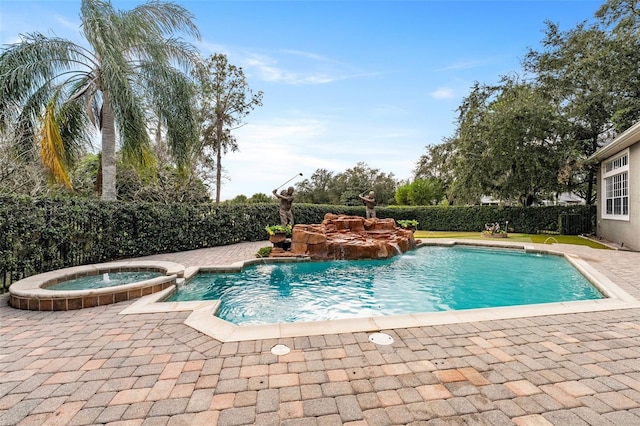 view of swimming pool with pool water feature and an in ground hot tub