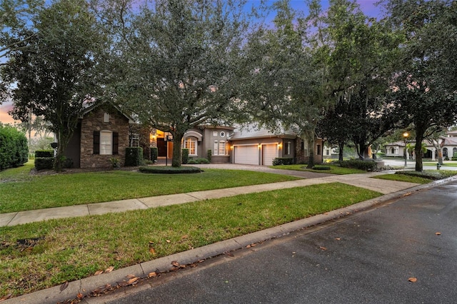 view of front facade featuring a lawn and a garage