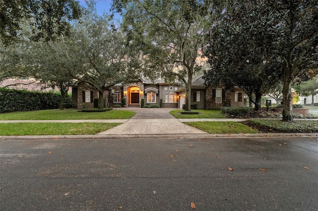 obstructed view of property featuring a front yard