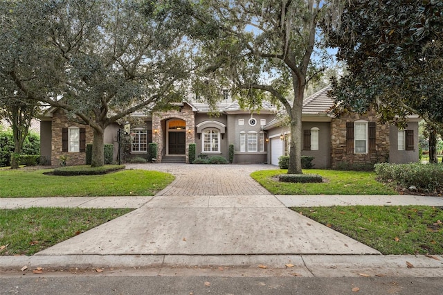 view of front of property with a front yard and a garage