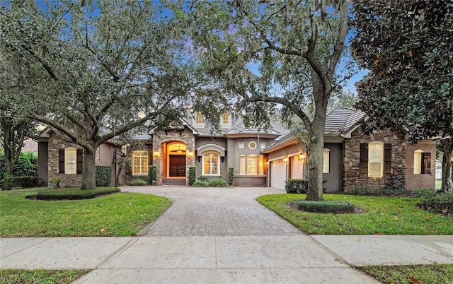 view of front of house featuring a garage and a front lawn