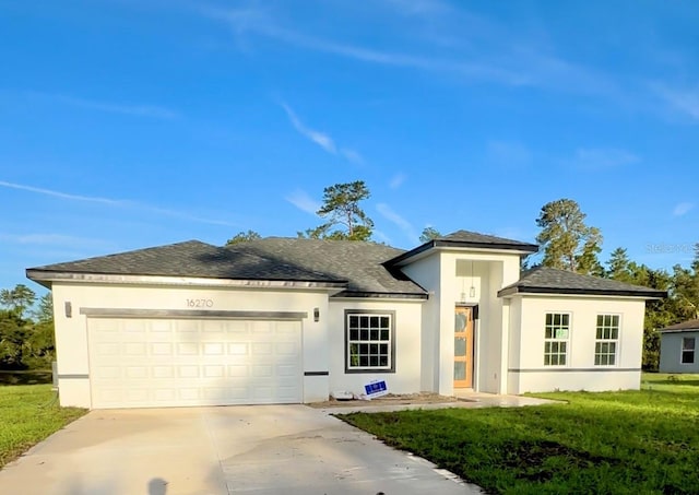 16270 SW 29th Court Rd, Ocala, FL 34473 - prairie-style home with an attached garage, stucco siding, concrete driveway, a front yard, and a shingled roof