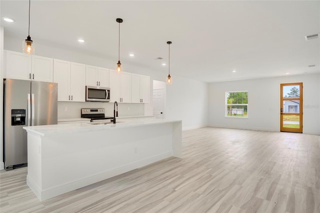 16270 SW 29th Court Rd, Ocala, FL 34473 - kitchen with appliances with stainless steel finishes, a center island with sink, light countertops, light wood-type flooring, and recessed lighting