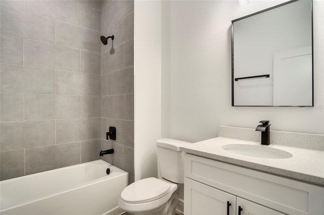 full bathroom with vanity, tiled shower / bath, and toilet