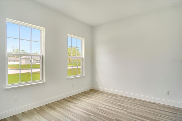 spare room featuring light hardwood / wood-style flooring