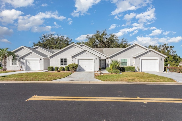 ranch-style home featuring a front lawn and a garage