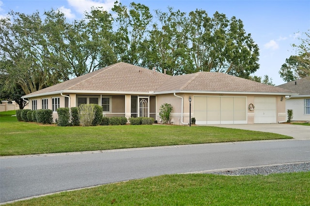 ranch-style house featuring a garage and a front lawn