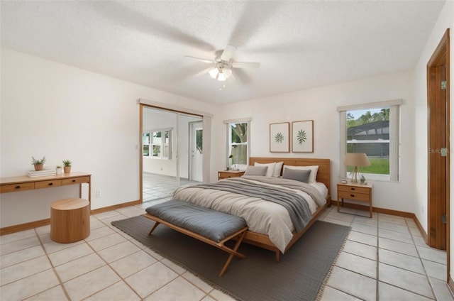 tiled bedroom with a textured ceiling, a closet, and ceiling fan