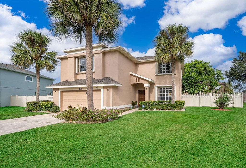 view of front of home with a front yard and a garage