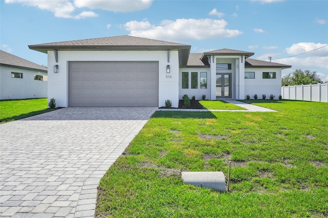 view of front of house with a garage and a front lawn