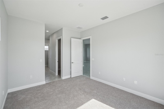 unfurnished bedroom featuring light carpet