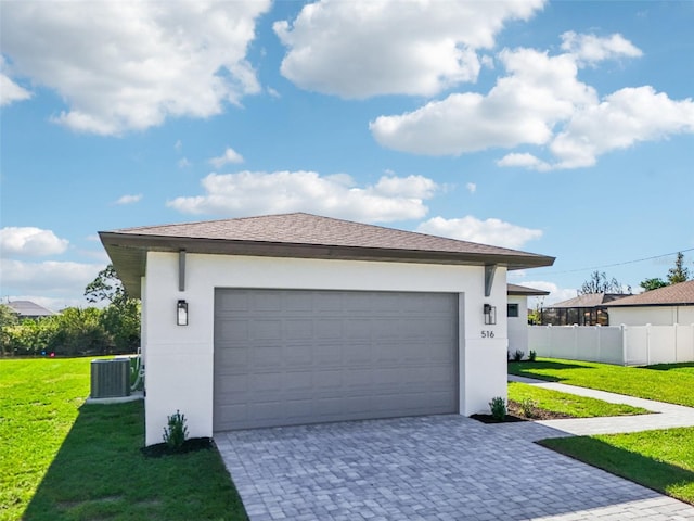 garage with a yard and central air condition unit