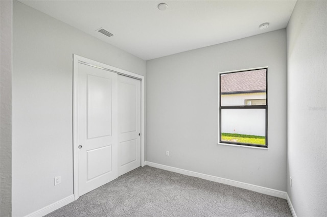 unfurnished bedroom with a closet and carpet