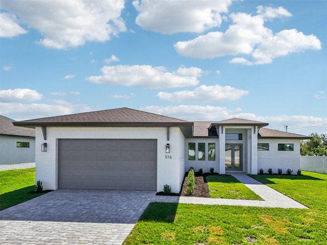 prairie-style house with a garage and a front lawn