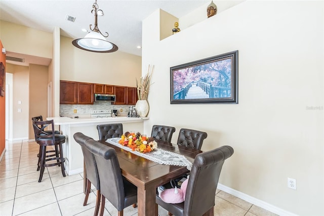 tiled dining area with a textured ceiling