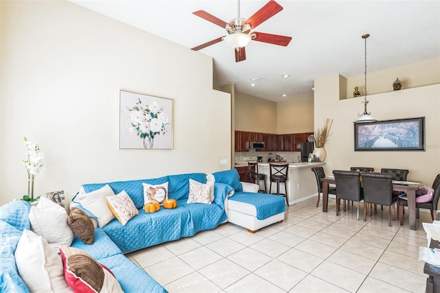 living room with ceiling fan and light tile patterned floors