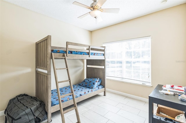 bedroom featuring ceiling fan and a textured ceiling