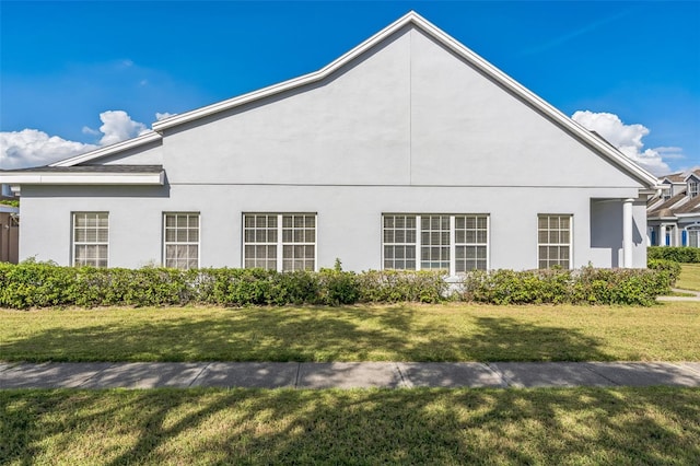 view of side of home featuring a yard