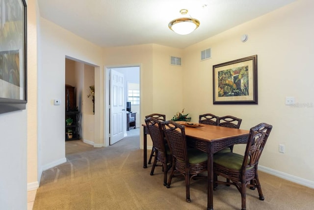 dining room featuring light colored carpet