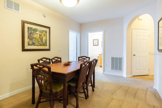 dining space featuring light colored carpet