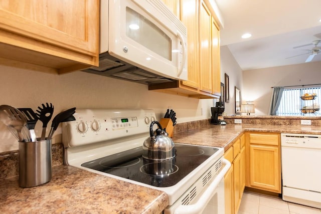 kitchen featuring light brown cabinetry, ceiling fan, light tile patterned floors, white appliances, and vaulted ceiling